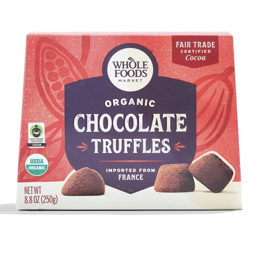 A box of Whole Foods Market Organic Chocolate Truffles, perfect for Christmas treat recipes, features "Imported from France." The packaging boasts "Fair Trade Certified Cocoa" and "USDA Organic" labels. Weighing 8.8 oz (250g), it includes a chocolate illustration in the background.